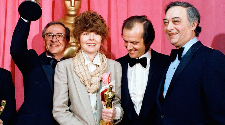 FILE - Oscar winners Charles H. Joffe, winner of best picture for "Annie Hall," left, and Diane Keaton, winner of best actress for "Annie Hall," poses with presenter Jack Nicholson, and producer Jack Rollins at the Academy Awards in Los Angeles on April 3, 1978. (AP Photo, File)