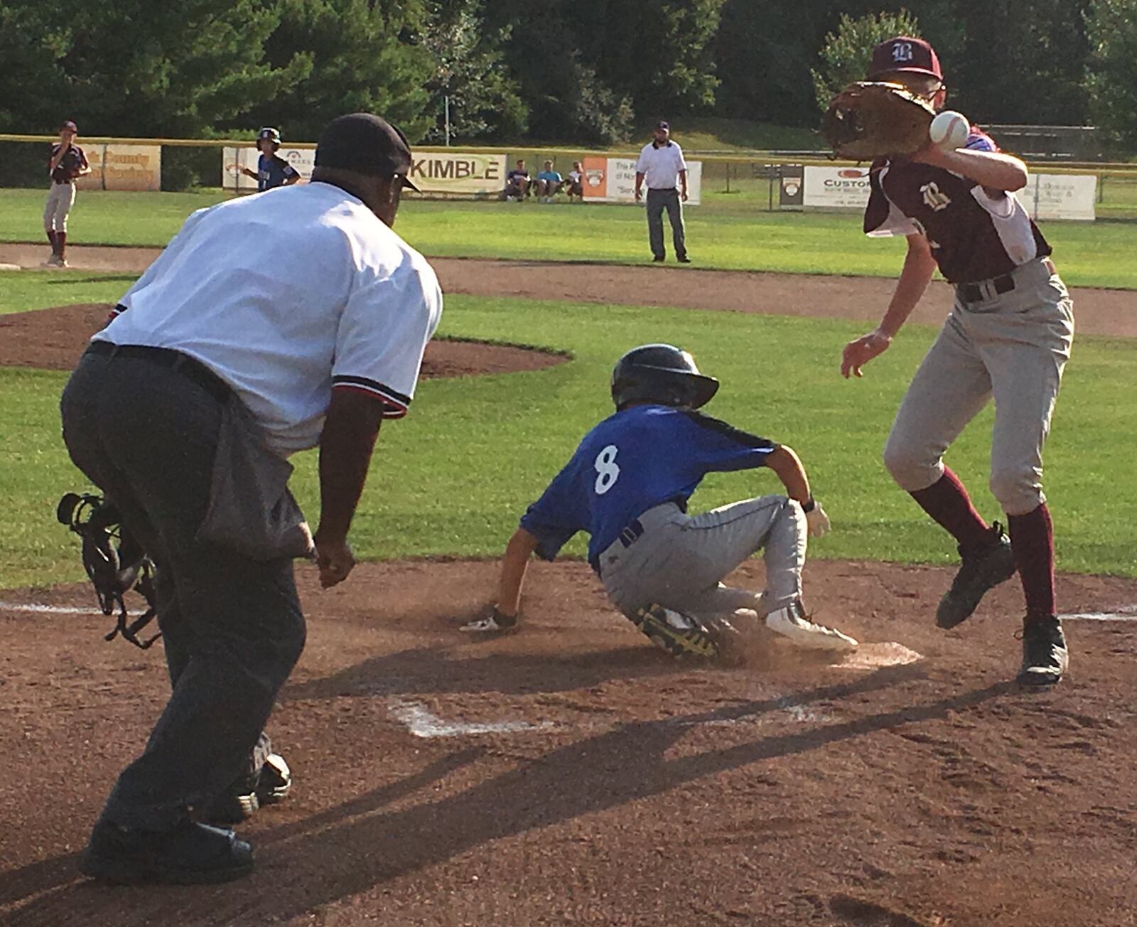 Hamilton West Side’s Ethan Stone clearly beats the throw back to Boardman pitcher Jack Ericson after a wild pitch Friday night during the losers’ bracket final of the Ohio Little League Tournament at the Hoover Community Recreation Complex in North Canton. Boardman registered a 5-4 win. RICK CASSANO/STAFF