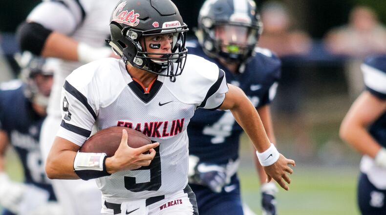 Franklin quarterback Braden Woods (9) carries the football during their game against Edgewood Friday, Aug. 31 at Edgewood’s field in St. Clair Township. NICK GRAHAM/STAFF