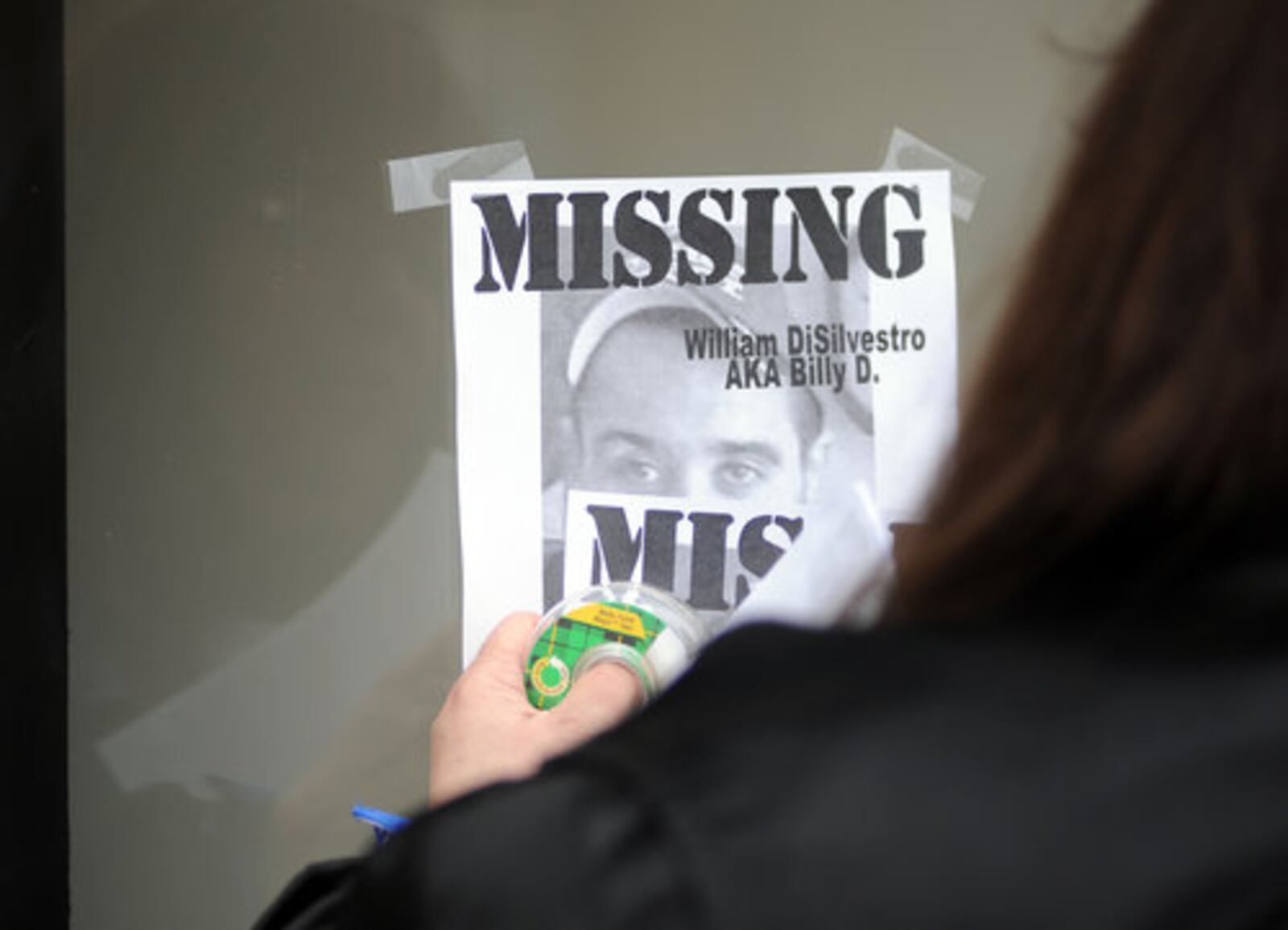 Debbie Estes papers the west side of Hamilton on Saturday, Feb. 26, 2011 with flyers of her son, William DiSilvestro, 28, who was reported missing Feb. 11. Known as Billy D., he suffers from epilepsy and was last seen on Ross Avenue. Over 100 people--friends, family and strangers--turned out to help her search. "I'm not a rich person but I feel rich today," she said, regarding the turnout to help her find her son.