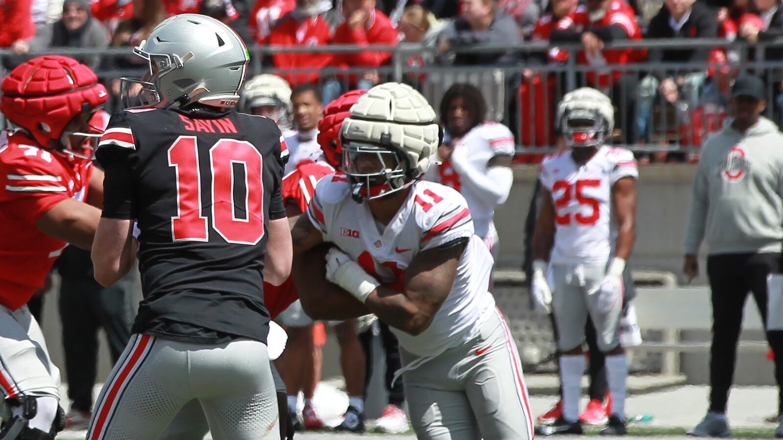 C.J. Hicks (11) rushes quarterback Julian Sayin during the 2025 Ohio State football spring game in Columbus.