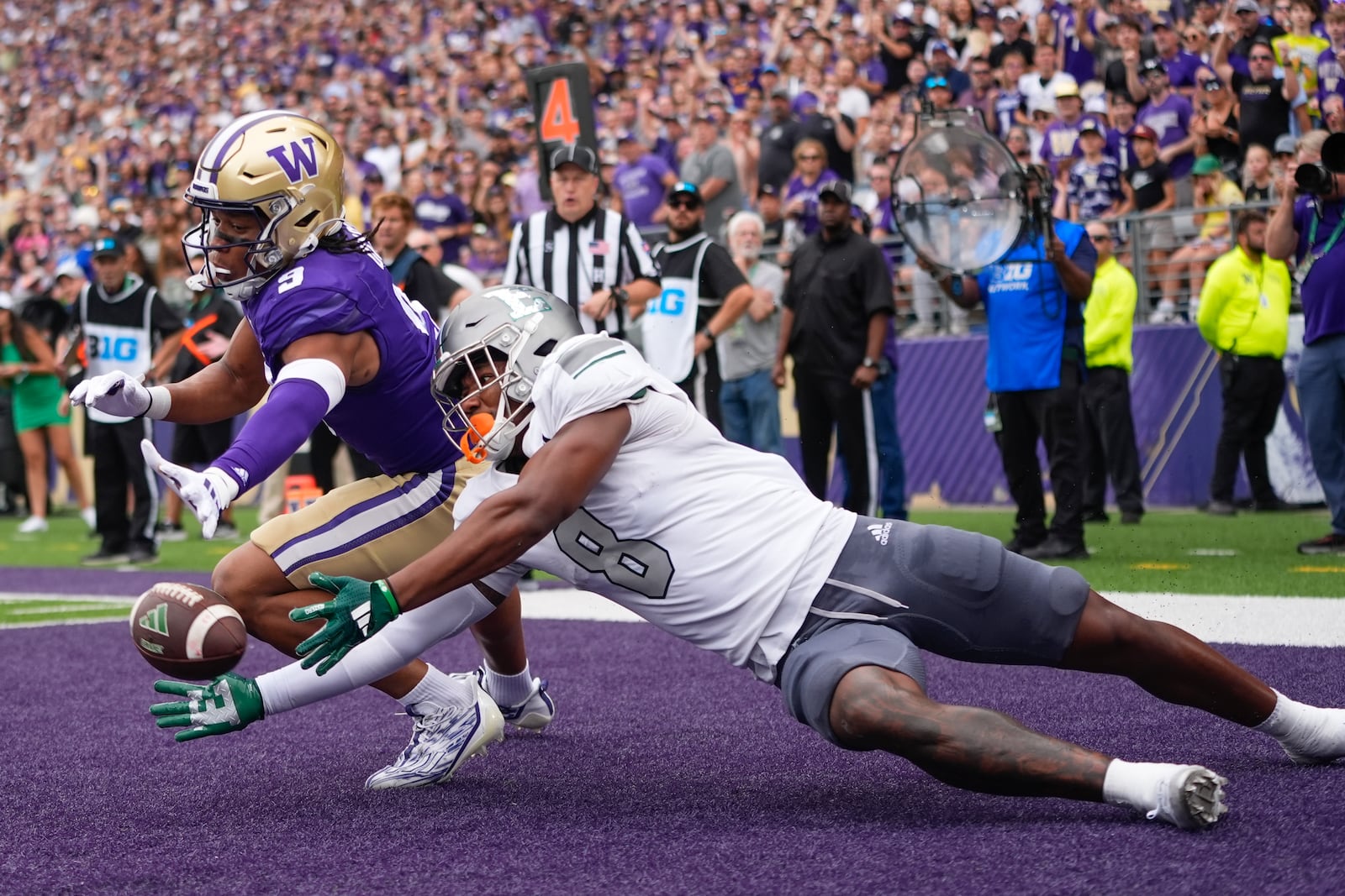 Washington cornerback Thaddeus Dixon (9) breaks up a pass in the end zone against Eastern Michigan wide receiver Markus Allen (8) during the first half of an NCAA college football game Saturday, Sept. 7, 2024, in Seattle. (AP Photo/Lindsey Wasson)