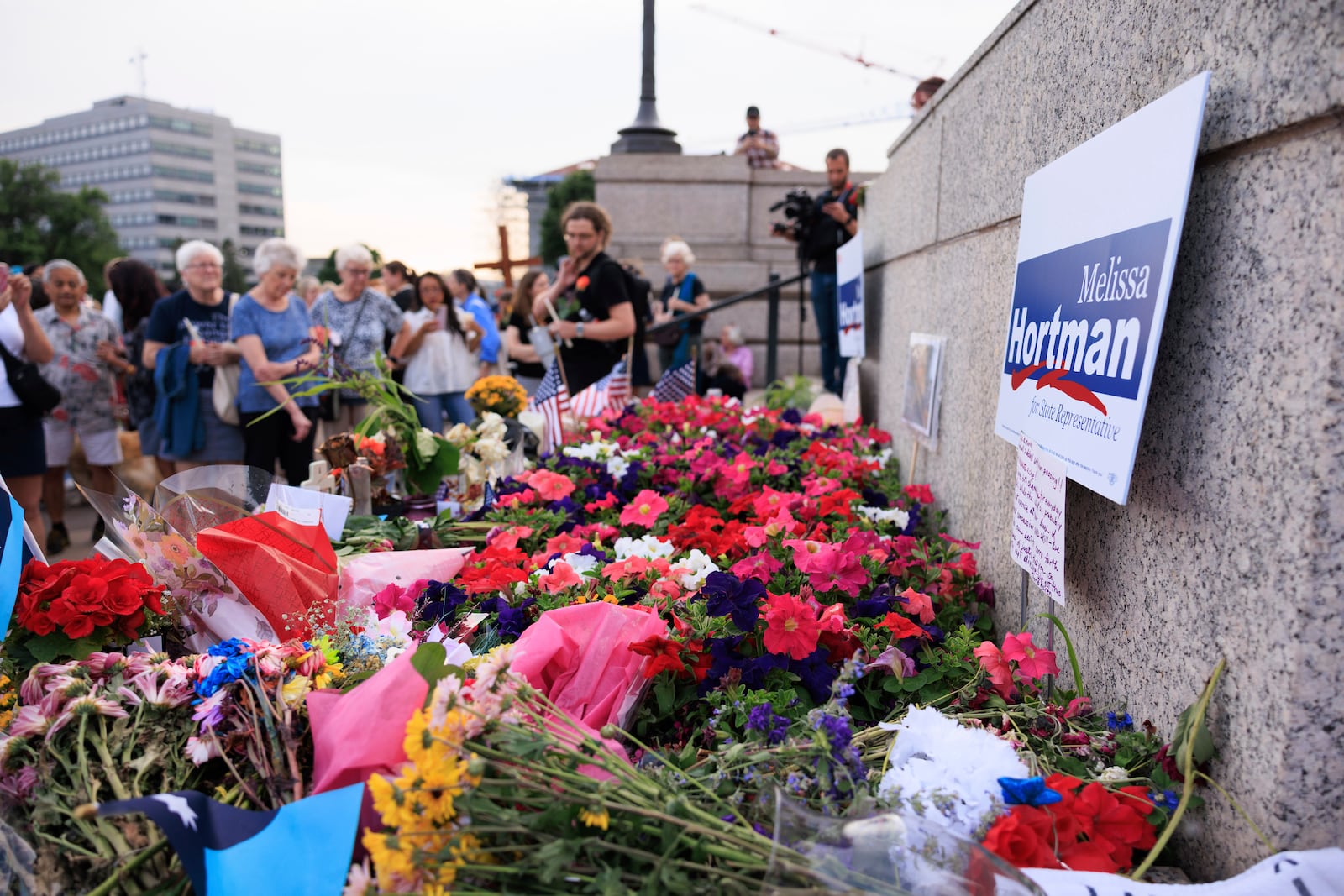 People attend a candlelight vigil for former House Speaker Melissa Hortman and her husband Mark, who were fatally shot, at the state Capitol, Wednesday, June 18, 2025, in St. Paul, Minn. (AP Photo/Nikolas Liepins)