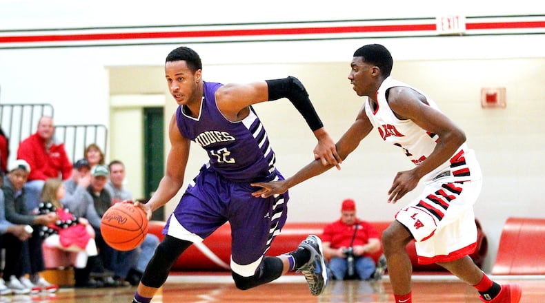 Middletown’s Vincent Edwards (12) dribbles the ball around Lakota West’s Latrell Tidwell (3) during a game at West on Jan. 10, 2014. JOURNAL-NEWS FILE PHOTO