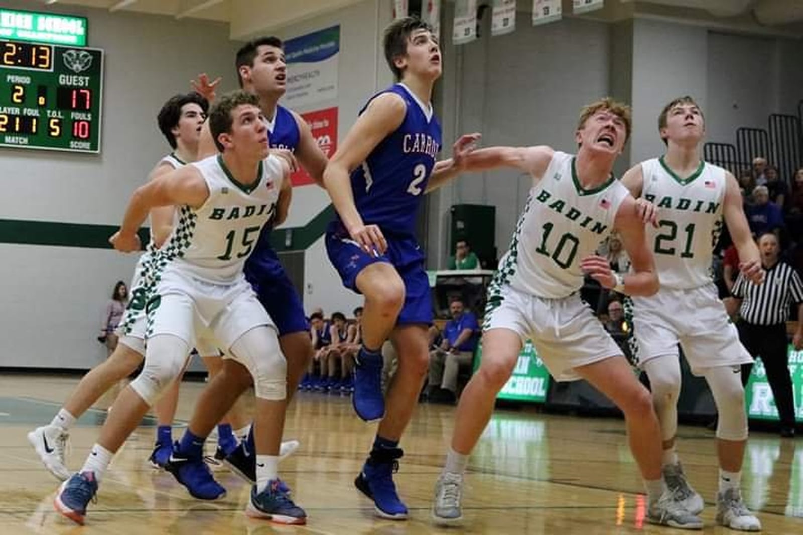 Badin’s John Berg (15), Zach Switzer (10) and Josh Hegemann (21) work for a rebound against Carroll’s Jaden Dahm (2) on Friday night at Mulcahey Gym in Hamilton. Badin won 43-42. CONTRIBUTED PHOTO BY TERRI ADAMS