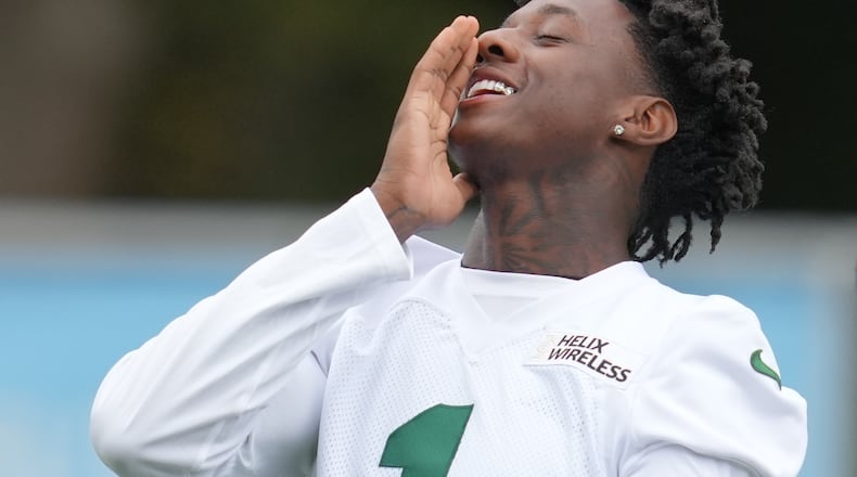 New York Jets cornerback Sauce Gardner (1), gestures during an NFL football practice at The Grove in Watford, England, Friday, Oct. 10, 2025. (AP Photo/Kin Cheung)