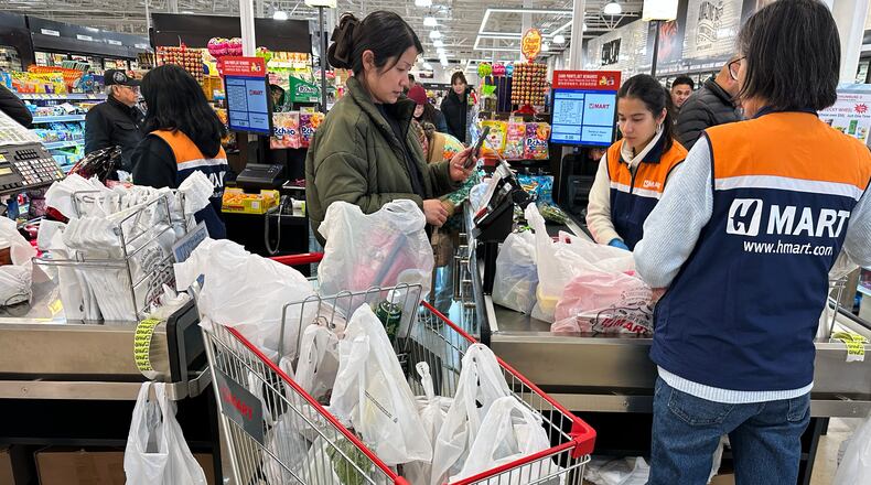 FILE - A shopper checks out at a cash register in a grocery store in Schaumburg, Ill., Monday, Feb. 9, 2026. (AP Photo/Nam Y. Huh, File)