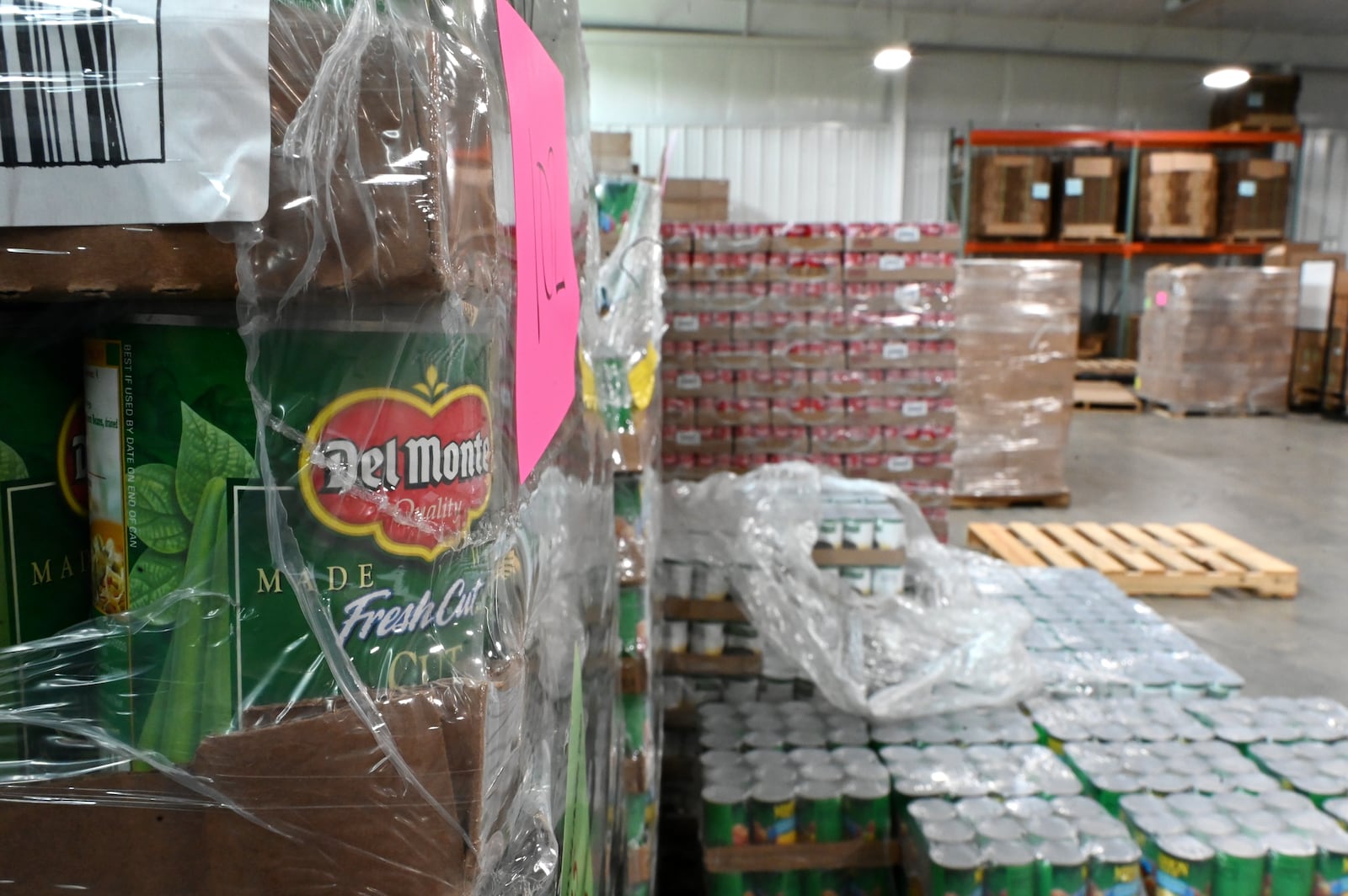 Pictured are pallets of cans of food at Shared Harvest Foodbank in Fairfield, Ohio, on Wednesday, July 9, 2025. The federal cut to Supplemental Nutrition Assistance Program, or SNAP, benefits with the passage of the so-called "One Big Beautiful Bill" approved by Congress and signed by President Donald Trump, organizations like Shared Harvest expect to see an increase in clients as federal food supplies decrease. "Our greatest concern is that we continue in the pattern of reducing food sources, and we continue to see growing numbers of people coming to our network,” said Shared Harvest Executive Director Terry Perdue. “It’s less food and more people needing access to charitable food.” MICHAEL D. PITMAN/STAFF