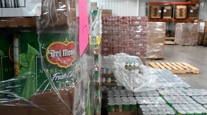Pictured are pallets of cans of food at Shared Harvest Foodbank in Fairfield, Ohio, on Wednesday, July 9, 2025. The federal cut to Supplemental Nutrition Assistance Program, or SNAP, benefits with the passage of the so-called "One Big Beautiful Bill" approved by Congress and signed by President Donald Trump, organizations like Shared Harvest expect to see an increase in clients as federal food supplies decrease. "Our greatest concern is that we continue in the pattern of reducing food sources, and we continue to see growing numbers of people coming to our network,” said Shared Harvest Executive Director Terry Perdue. “It’s less food and more people needing access to charitable food.” MICHAEL D. PITMAN/STAFF