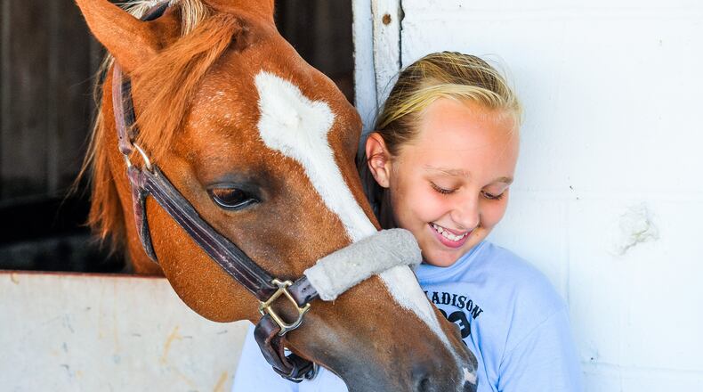 Lyla Comer, 10, with Madison Outlaws 4-H Club, stands with her horse, Annie, during the 2018 Butler County Fair on July 26 at the Butler County Fairgrounds in Hamilton.