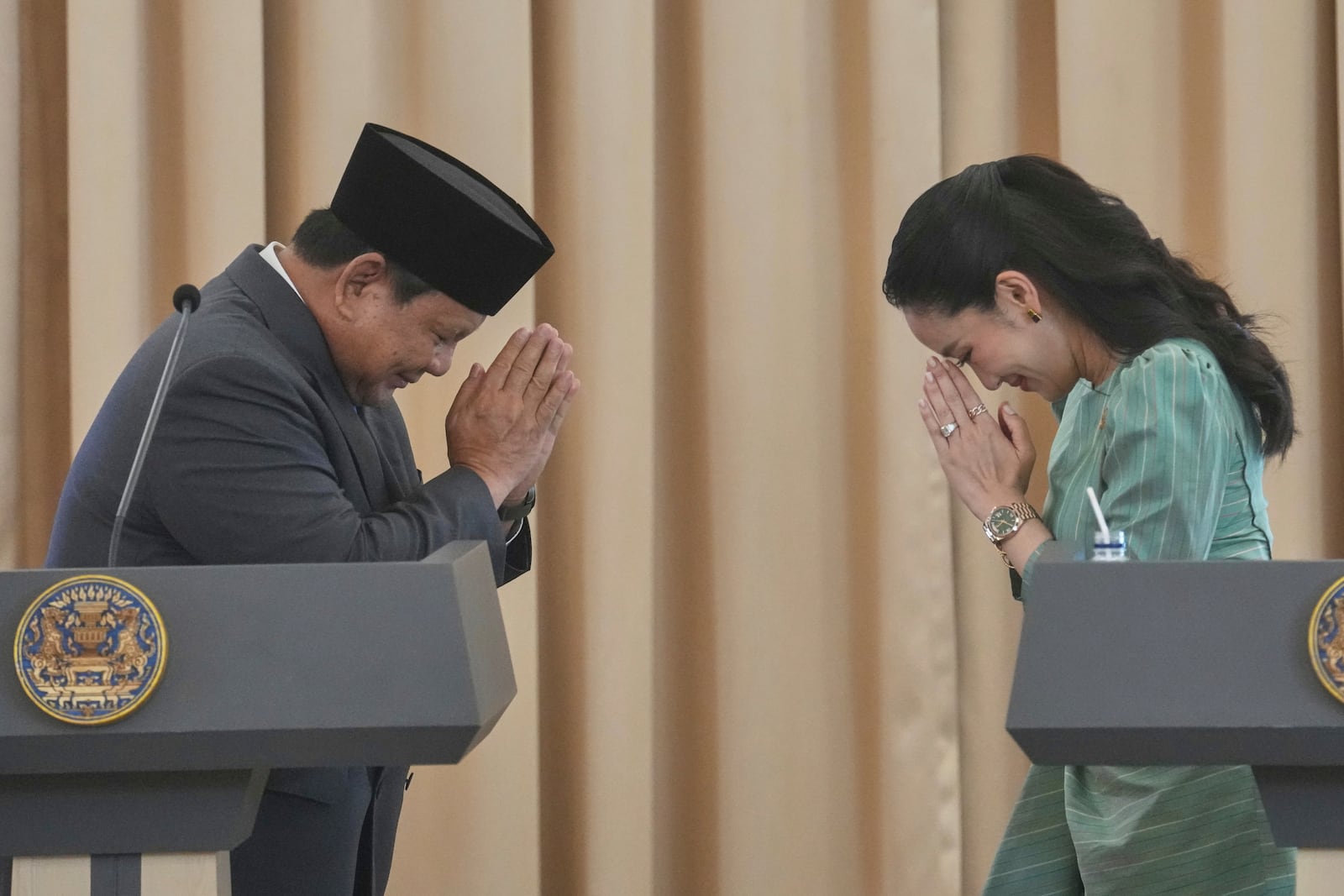 Indonesian President Prabowo Subianto, left, greets with Thai way tradition 'Wai" to Thailand's Prime Minister Paetongtarn Shinawatra after their joint press conference at the government house in Bangkok, Thailand, Monday, May 19, 2025. (AP Photo/Sakchai Lalit)