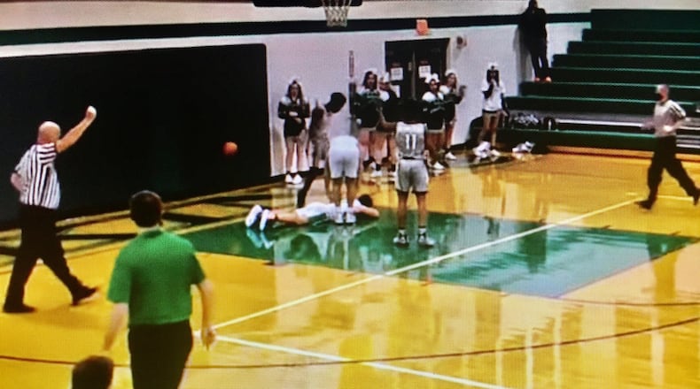 A screen shot photo from a game video posted online by Butler County Sports Report shows an Cincinnati Oyler High School player standing over a New Miami High School player he just fouled. Officials from both schools continued to investigate the Oyler player's alleged kicking of the prone New Miami player in the head. (Butler County Sports Report image)