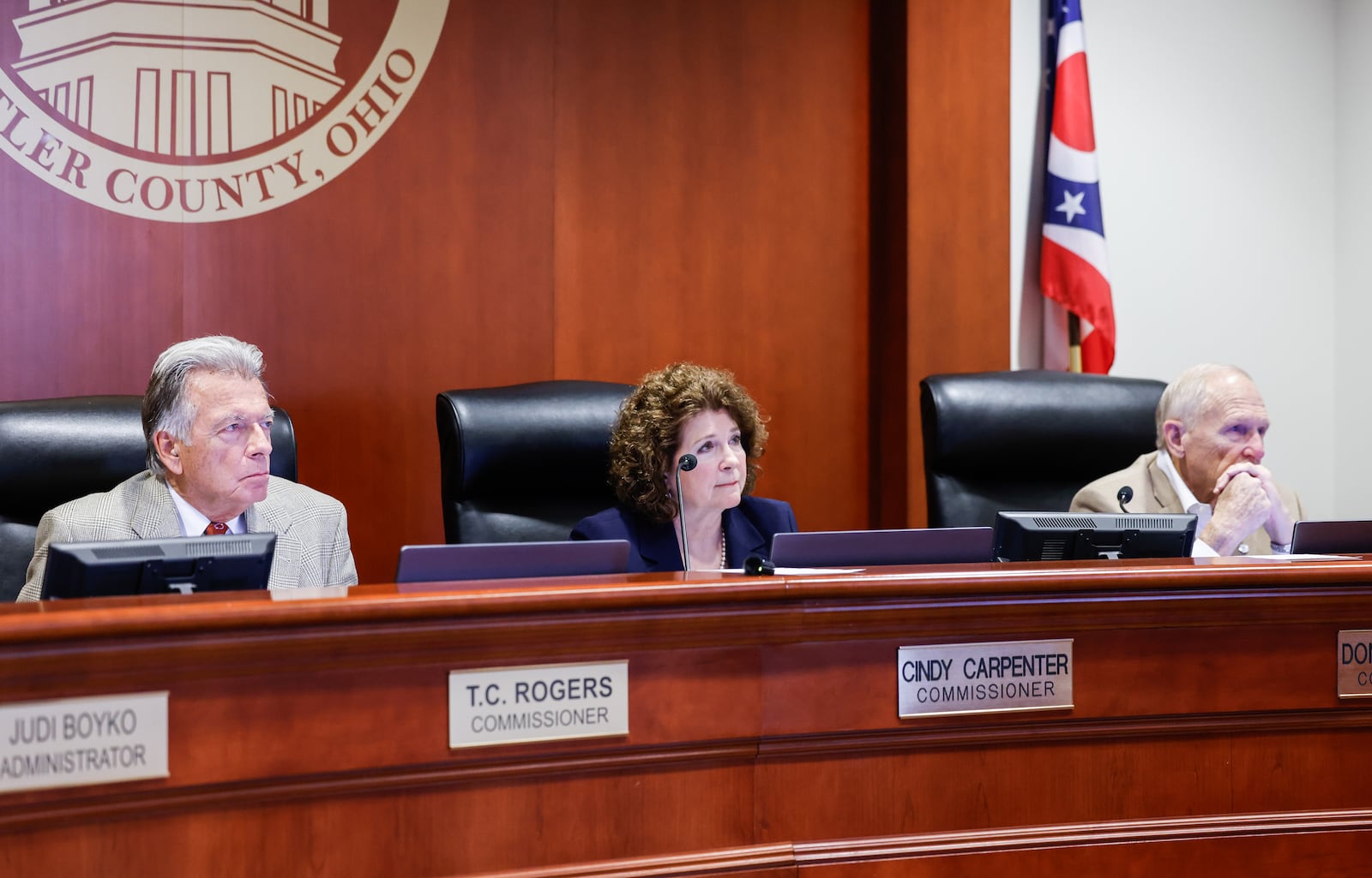 Butler County Commissioners T.C. Rogers, left, Cindy Carpenter, middle, and Don Dixon listen as a group with Butler County for Immigrant Justice attended the meeting to express their concerns over U.S. Immigration and Customs Enforcement detainees being housed in the Butler County jail and ask commissioners to end the contract. NICK GRAHAM/STAFF