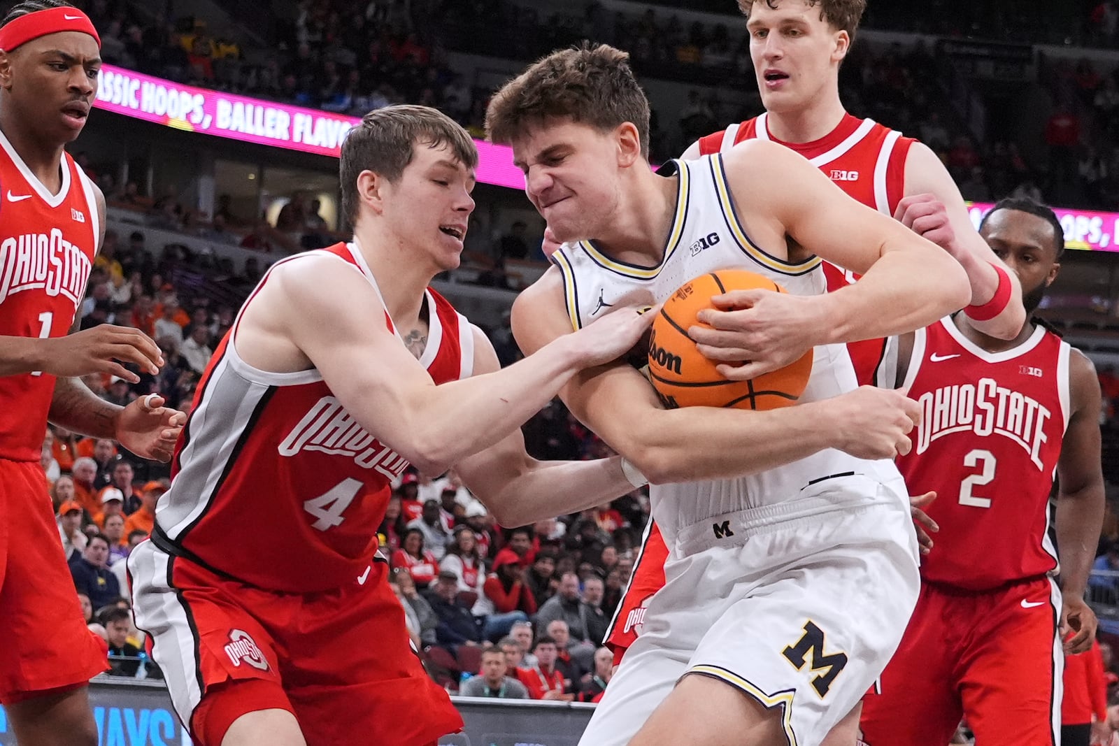 Michigan forward Will Tschetter, right, battles for the ball with Ohio State guard Gabe Cupps during the second half of an NCAA college basketball game in the quarterfinals of the Big 10 Conference tournament, Friday, March 13, 2026, in Chicago. (AP Photo/Nam Y. Huh)