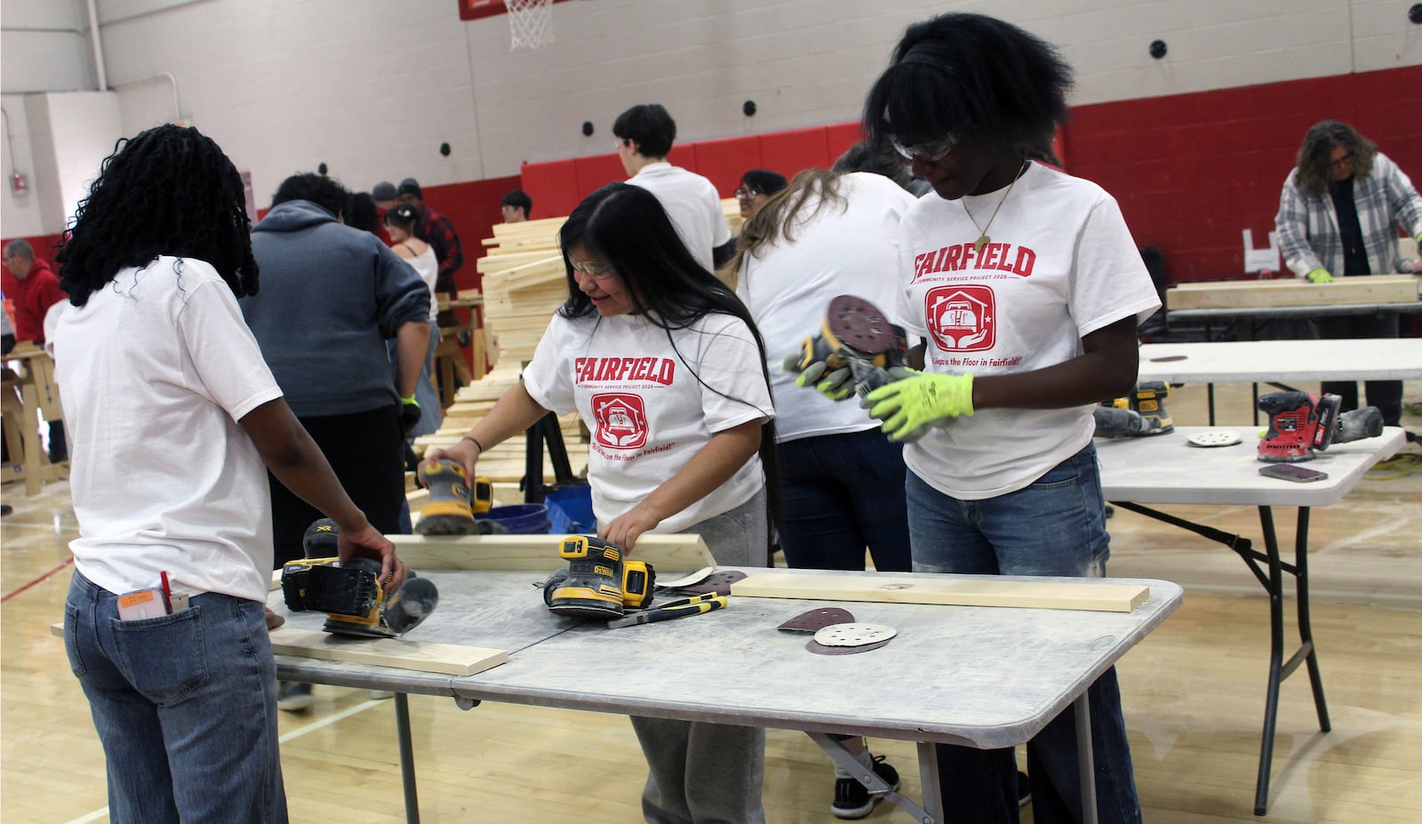 Beverly Darlington, Ella Ondouanongo, and Jennifer Perez sanded down cut wood as part of an effort to build 100 beds by Fairfield High School students in cooperation with Sleep in Heavenly Peace. SUE KIESEWETTER/CONTRIBUT
