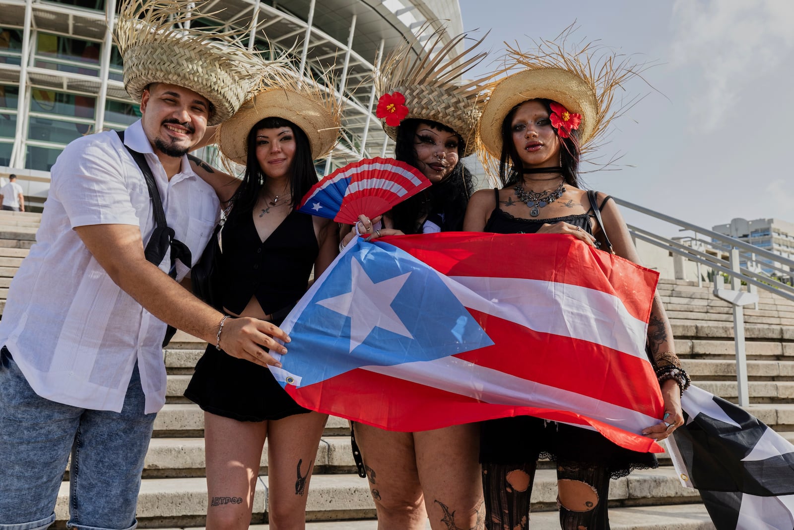 Bad Bunny fans pose for a photo before attending the first show of his 30-date concert residency at the Coliseo de Puerto Rico Jose Miguel Agrelot in San Juan, Puerto Rico, Friday, July 11, 2025. (AP Photo/Alejandro Granadillo)