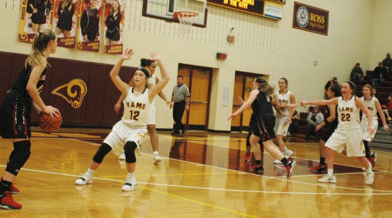 Payton Voegele (12) of Ross defends Talawanda’s Sophie Pohlabel (14) during Wednesday night’s game in Ross Township. The host Rams won 26-25. RICK CASSANO/STAFF