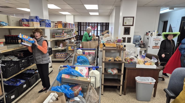 Volunteers load food and other goods at the Franklin Area Community Services Food Pantry. Demand for help is up in spite of federal rulings that the SNAP program must be funded during the government shutdown. MICHAEL KURTZ/STAFF