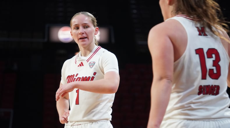 Miami’s Amber Scalia (1) celebrates a basket with teammate Tamar Singer after Scalia was fouled during her game against Buffalo on Wednesday night at Millett Hall. CHRIS VOGT / CONTRIBUTED