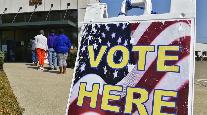 Voters line up at the Butler County Board of Elections on the first day of early voting Tuesday, October 6, 2020 in Hamilton. More than 2,200 people voted on the first day of early voting, a record in Butler County. NICK GRAHAM / STAFF