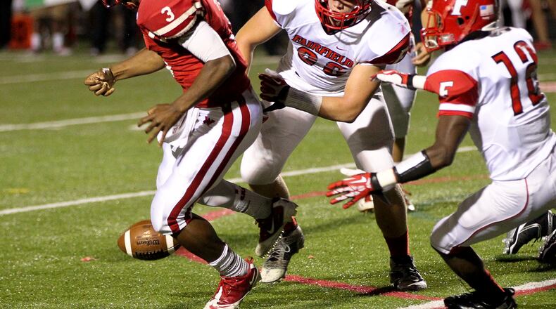 Fairfield linebacker Hunter Nunnelley (36) knocks the ball loose from Lakota West quarterback Malik Grove (3) during Friday night's game at Lakota West High School Oct. 11, 2013. Lakota West defeated Fairfield 35-3. NICK DAGGY / STAFF