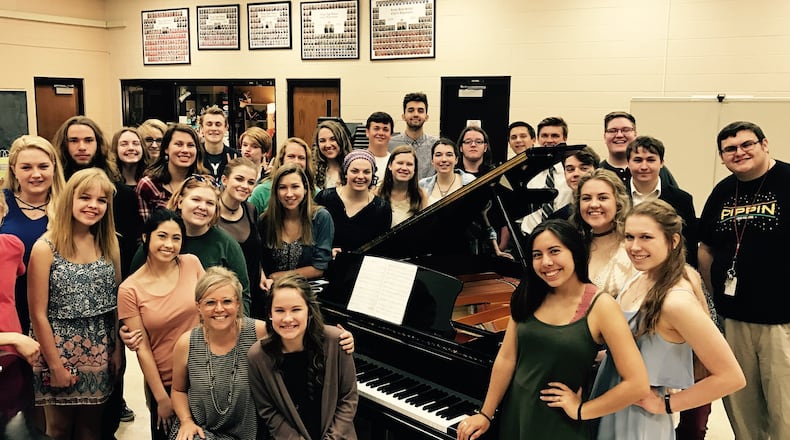 Seeking to honor her family, friends and faith, Kings High School sophomore Brooke Howard recently donated a grand piano to her school’s choir department. Brooke is shown here (front center) with choir director Hope Milthaler (seated next to Howard) and the KHS Chamber Choir. CONTRIBUTED