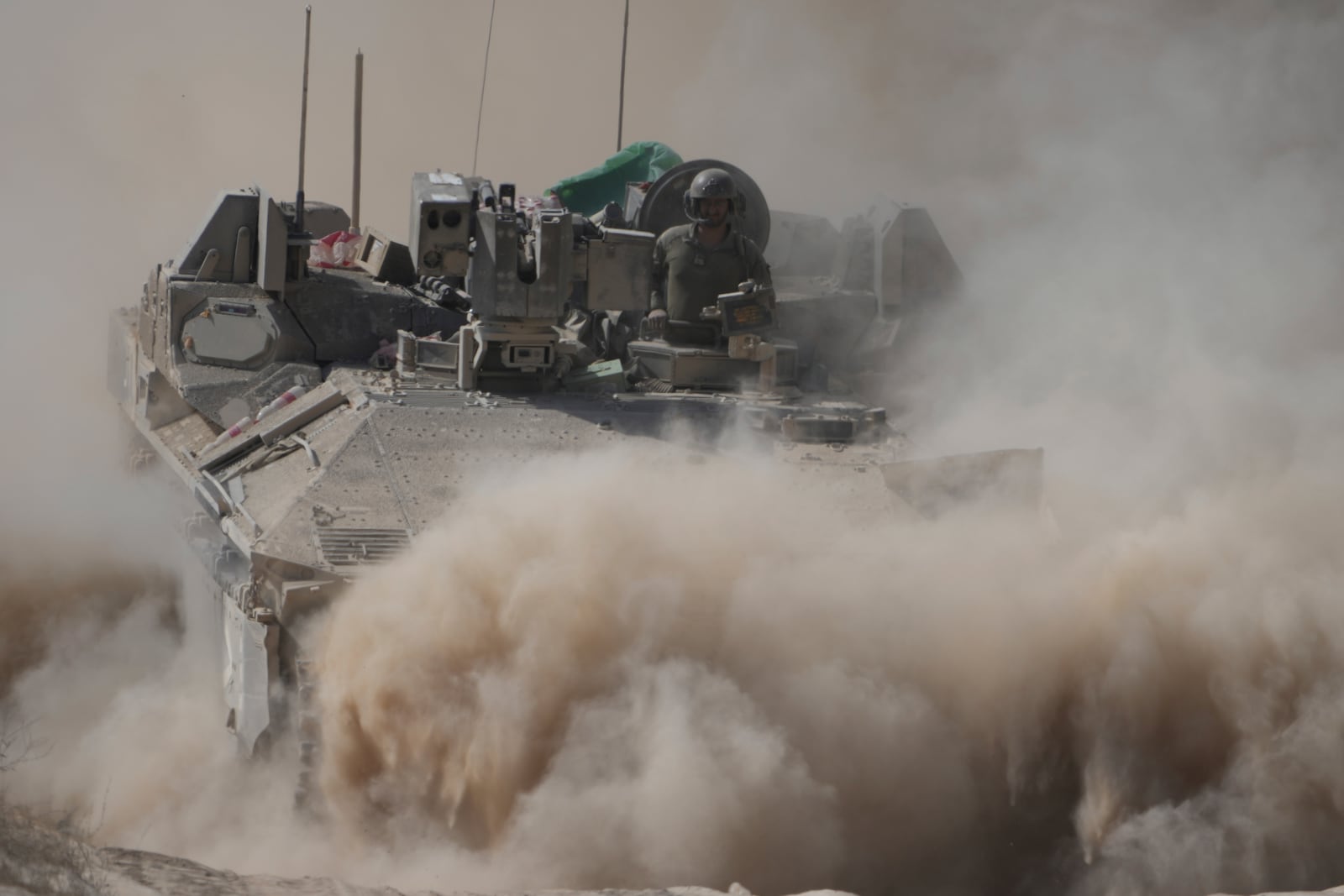 An Israeli army tank maneuvers near the Israel-Gaza border, southern Israel, Wednesday, June 11, 2025. (AP Photo/Ariel Schalit)