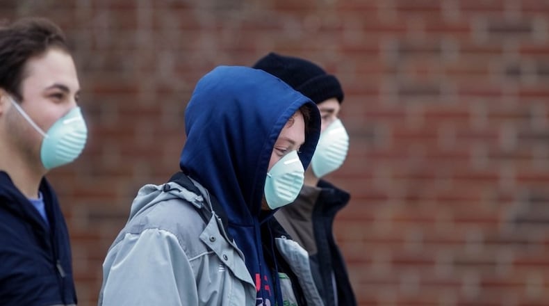 Miami University students wear masks at the main campus in Oxford Jan. 28, 2020, after administrators announced two students are in isolation and were tested for possible novel coronavirus infection.