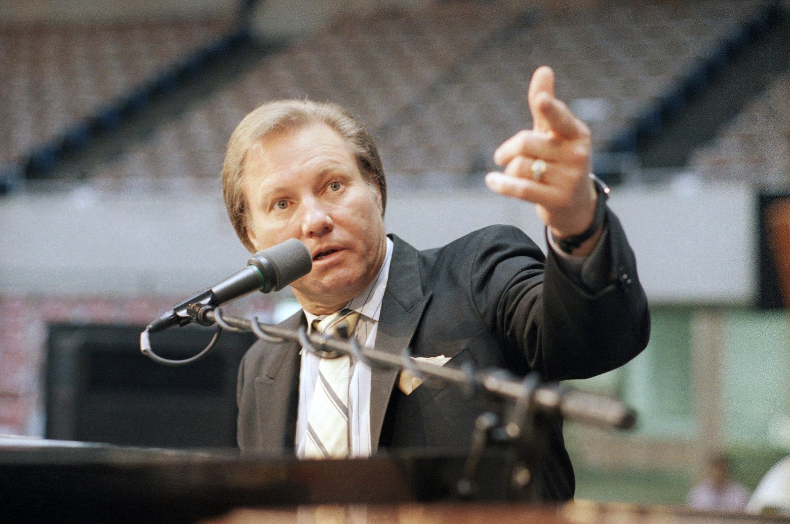 FILE - Rev. Jimmy Swaggart raises his fist to make point at news conference at the Sports Arena in Los Angeles, Friday, March 27, 1987. (AP Photo/Lennox McLendon, file)