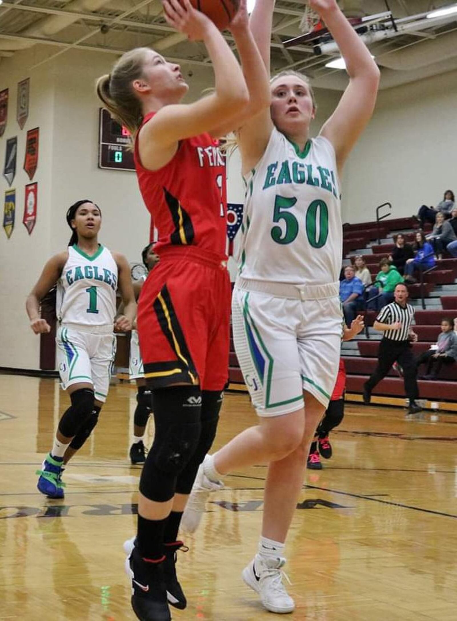 Fenwick’s Hannah Tebbe (2) goes up for a shot against Chaminade Julienne’s Eve Monaghan (50) during Saturday afternoon’s Division II sectional opener at Lebanon. Fenwick won 38-35. CONTRIBUTED PHOTO BY TERRI ADAMS