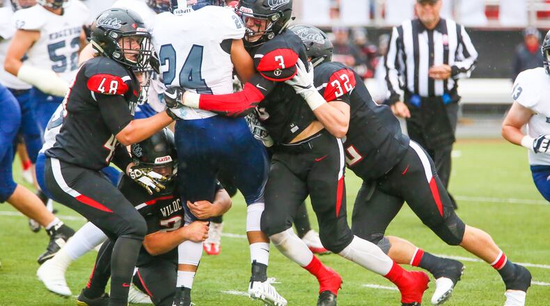 Edgewood running back Elijah Williams (24) is stood up by the Franklin defense during their game at Atrium Stadium in Franklin on Sept. 1. The host Wildcats won 49-21. GREG LYNCH/STAFF