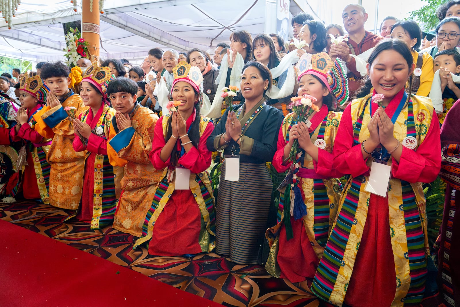 Exiled Tibetans in traditional costumes sing 'Happy Birthday' for their spiritual leader the Dalai Lama, unseen, as he leaves after attending his 90th birthday celebrations at the Tsuglakhang temple in Dharamshala, India, Sunday, July 6, 2025.(AP Photo/Ashwini Bhatia)