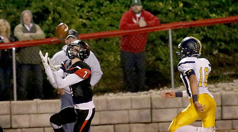 Franklin wide receiver Jared Kinzer pulls down a touchdown pass in front of Oakwood defensive back Alec Barhorst during their game at Atrium Stadium in Franklin on Friday night. The host Wildcats won 66-48 to remain undefeated. CONTRIBUTED PHOTO BY E.L. HUBBARD
