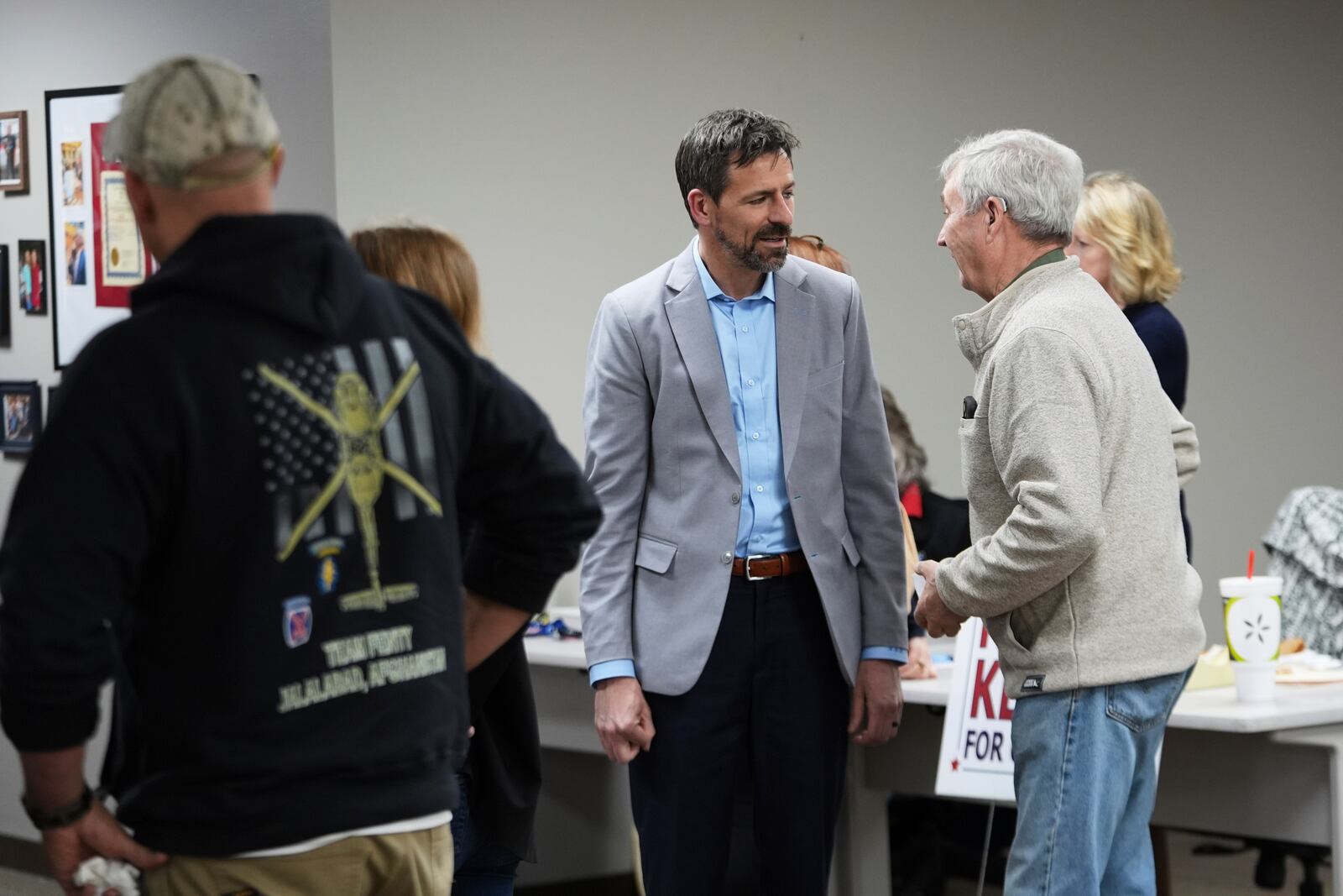 Ryan Kelley, left, talks with William "Hank" Choate before speaking at the Jackson County Republican headquarters Thursday, April 10, 2025, in Jackson, Mich. (AP Photo/Paul Sancya)