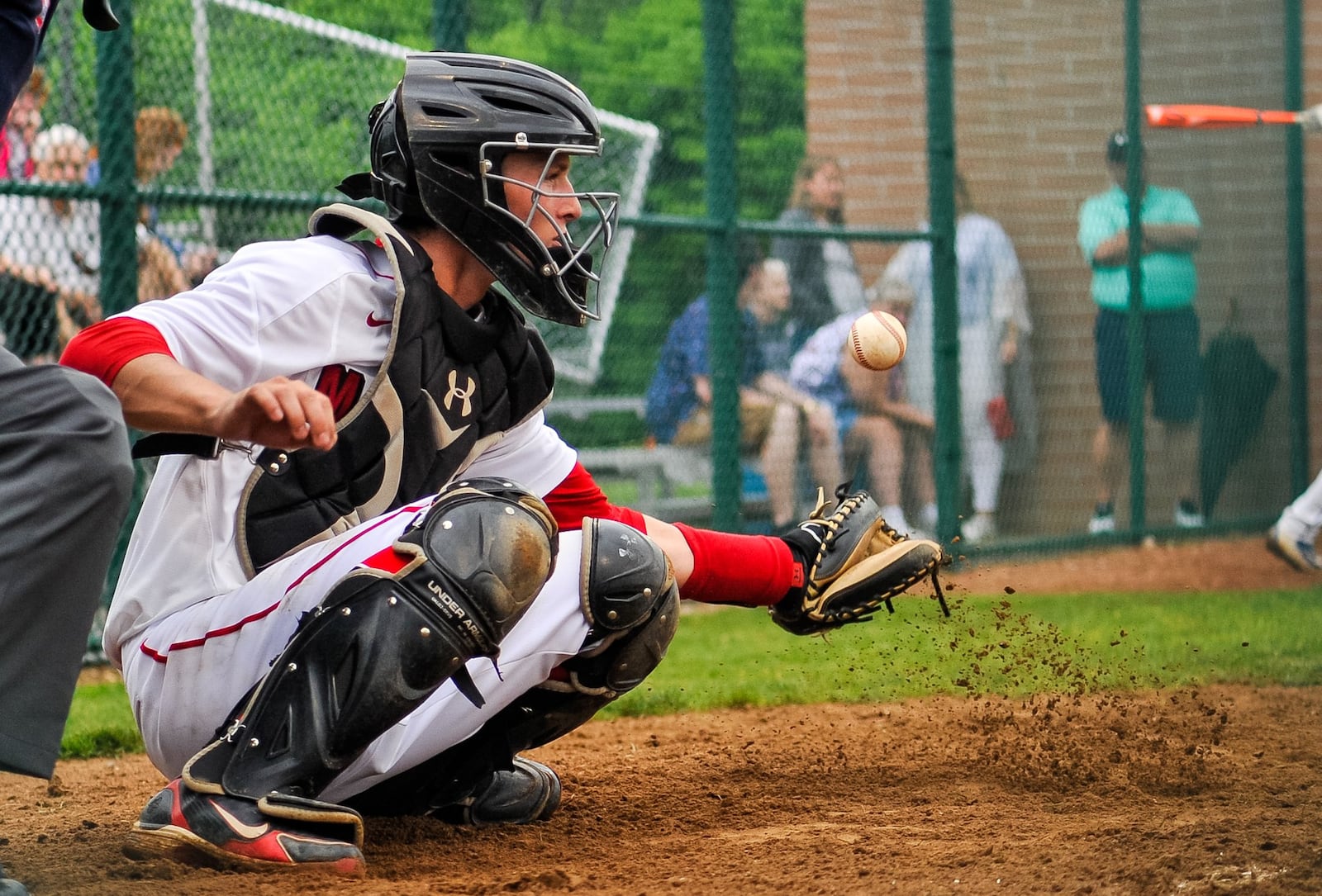 Madison catcher Cameron Svarda snags a ball out of the dirt Wednesday during a 4-2 triumph over Madeira in a Division III district baseball championship game at Hamilton. NICK GRAHAM/STAFF