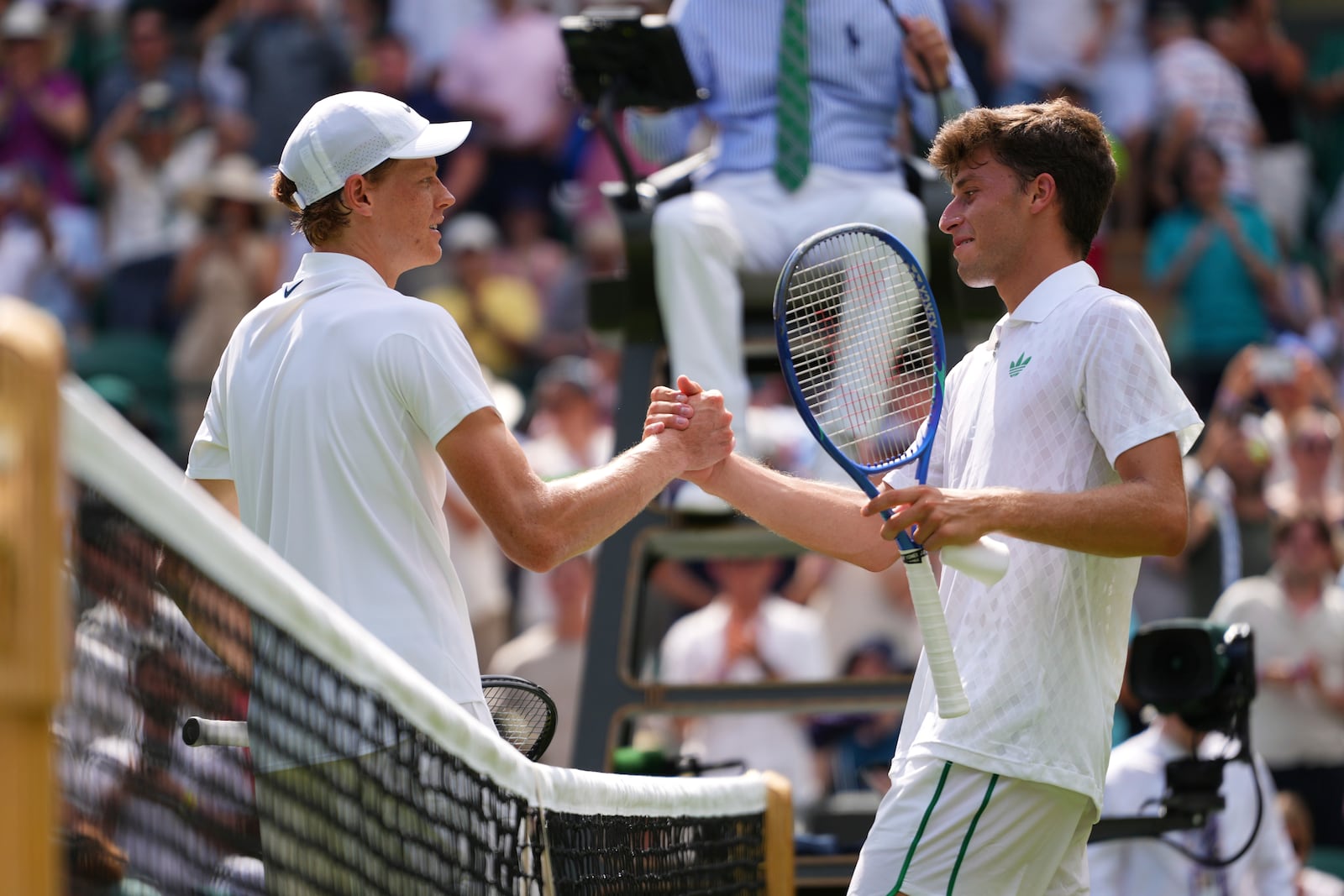 Jannik Sinner of Italy shakles hands after winning his first round men's singles match against Luca Nardi of Italy during at the Wimbledon Tennis Championships in London, Tuesday, July 1, 2025.(AP Photo/Kirsty Wigglesworth)