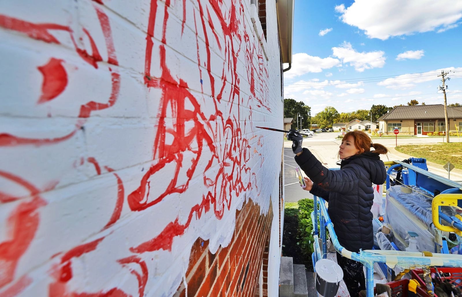 Spanish artist Lula Goce is in town painting Springboro's first public mural on the side of a building at 15 S. Main Street. Goce has traveled all over the world creating large wall murals. NICK GRAHAM/STAFF