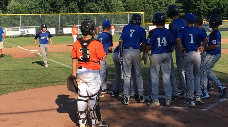 Hamilton West Side’s Jonathan Alcorn is about to be greeted by his teammates at home plate after his second-inning home run against Ironton on Wednesday night in the Ohio Little League Tournament at the Hoover Community Recreation Complex in North Canton. West Side won 13-3 in five innings. RICK CASSANO/STAFF