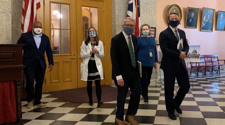 Lt. Gov. Jon Husted, Ohio Department of Health Dr. Amy Acton and Ohio Gov. Mike DeWine walk to their daily press conference Tuesday about the state’s action due to the coronavirus outbreak.