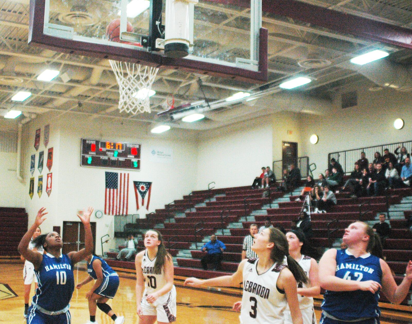 Hamilton’s Miracle Riggins (10, blue) and Samantha Fuller (42), along with Lebanon’s Isabella Dunn (10) and Samantha Feldmann (3), are waiting to see if the ball will go through the basket during Monday night’s game at Lebanon. Visiting Big Blue won 52-42. RICK CASSANO/STAFF