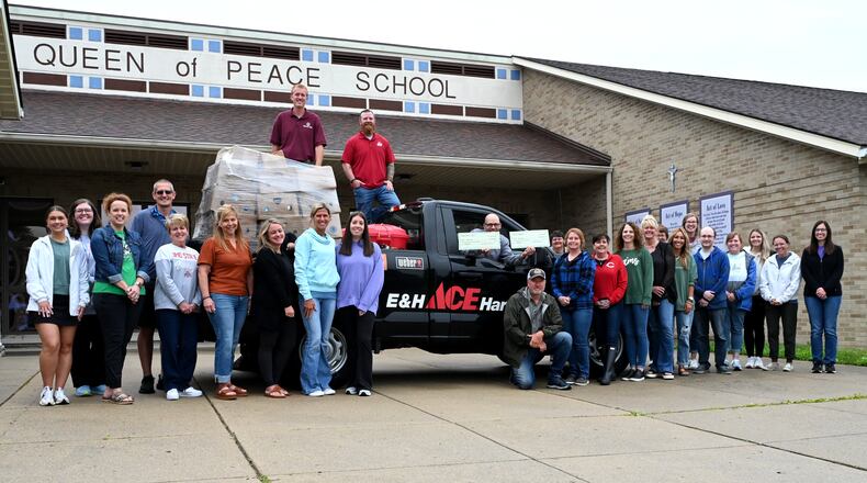 Queen of Peace, E&H Ace Hardware and Kroger donated money and food to Serve City, which is part of the ongoing relationship between the school and the shelter for the unhoused. Pictured is the donation made on May 30, 2025, at the Queen of Peace Catholic School on Millville Avenue. MICHAEL D. PITMAN/STAFF