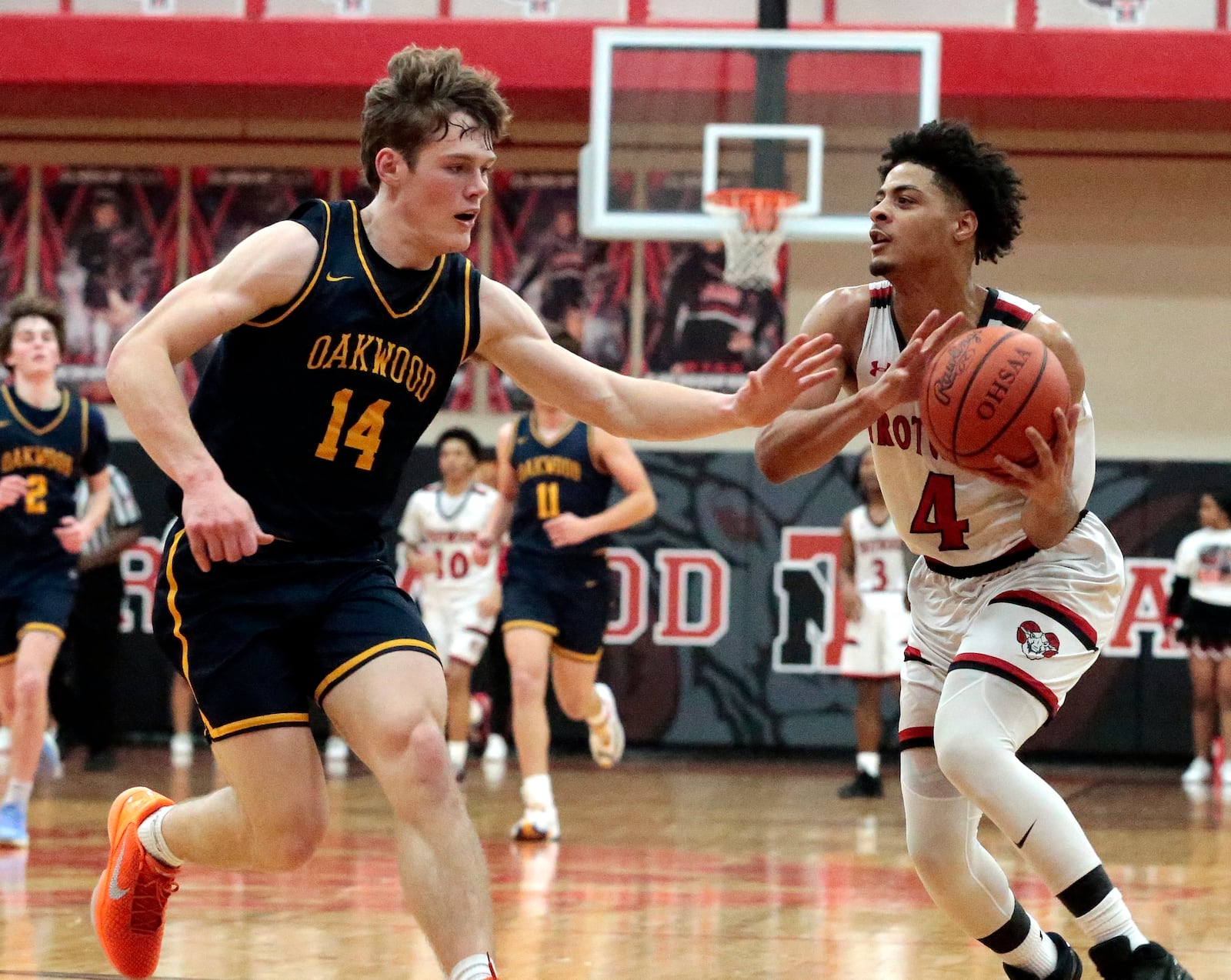 Trotwood senior Daveon Arnold looks to pass inside past Oakwood junior Michael Woeste. Trotwood defeated Oakwood 71-44 on Tuesday, Feb. 17, 2026, in Trotwood. STEVEN WRIGHT / STAFF