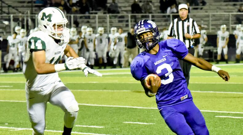 Middletown’s Vince Calhoun carries the ball during the first half of a game against Mason on Oct. 23, 2015, at Barnitz Stadium in Middletown. NICK GRAHAM/STAFF