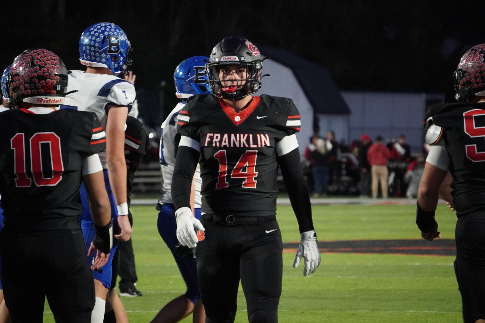 Franklin senior linebacker Braydon Isaacs returns to the huddle after making a tackle against Brookville on Friday night at Atrium Stadium. CHRIS VOGT / CONTRIBUTED