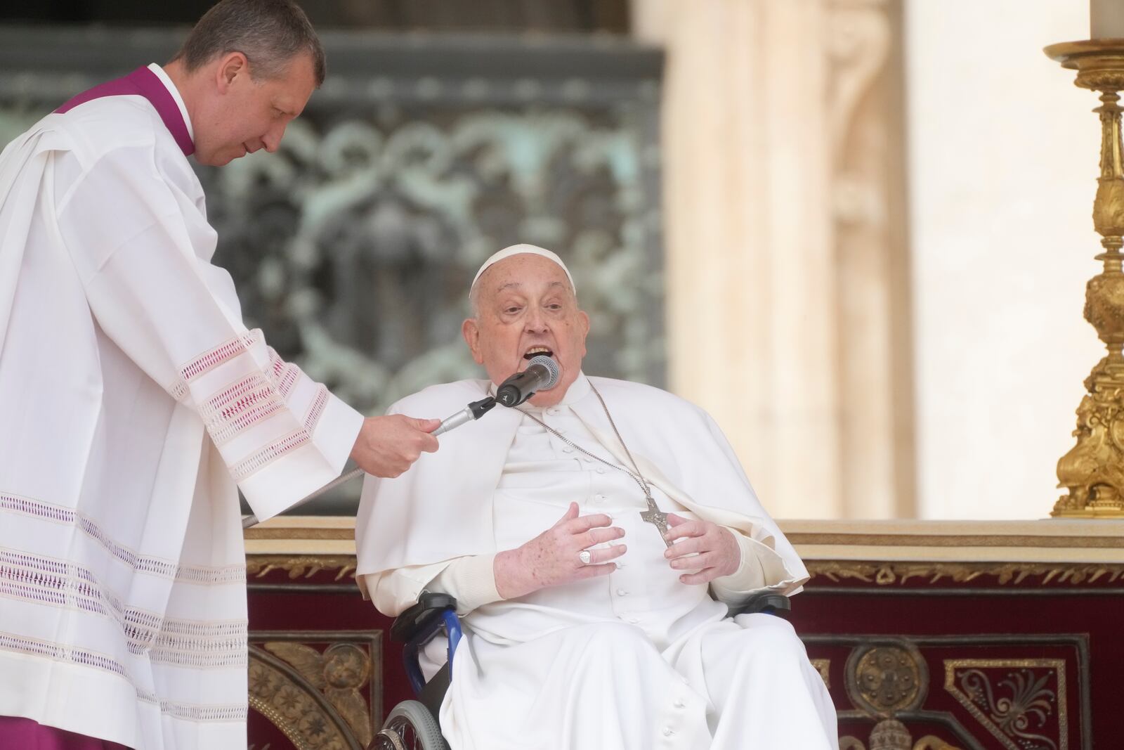 Monsignor Massimiliano Matteo Boiardi holds the microphone for Pope Francis as he wishes happy Palm Sunday and Easter Festivities to the faithful who attended the mass on Palm Sunday in St. Peter's Square at The Vatican, Sunday, April 13, 2025. (AP Photo/Gregorio Borgia)