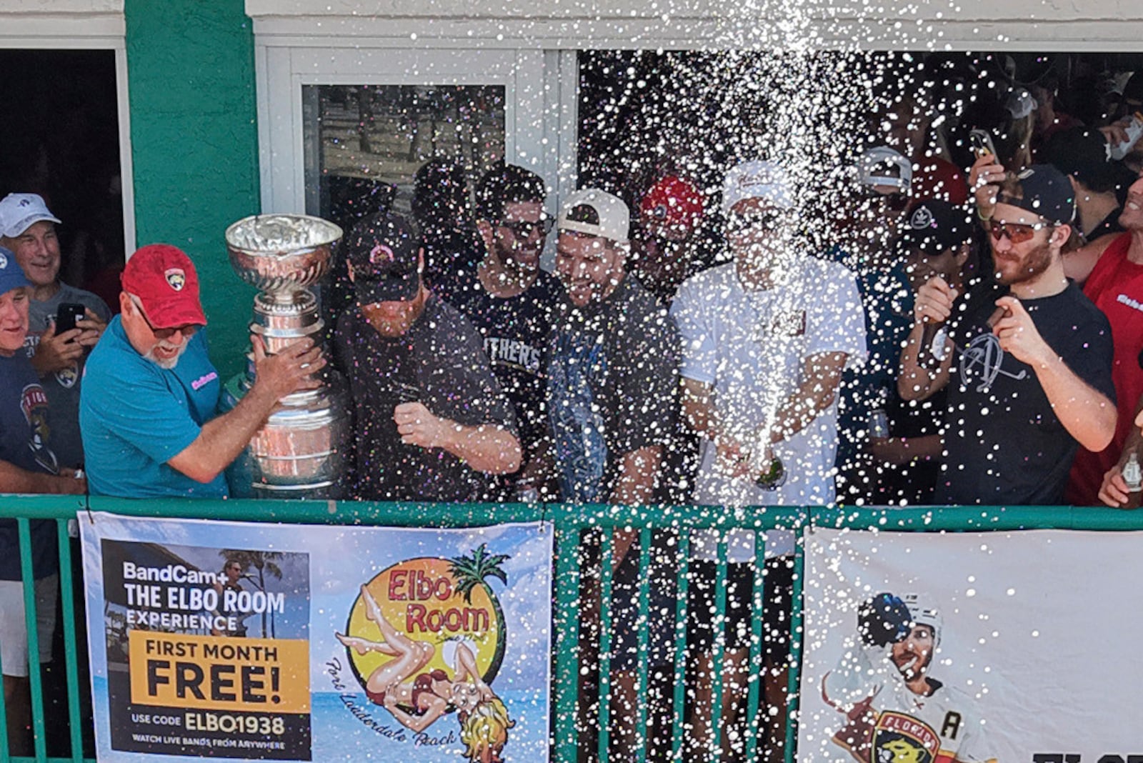 Members of the Florida Panthers hockey team celebrate with fans outside the Elbo Room, Wednesday, June 18, 2025, in Fort Lauderdale, Fla., the morning after defeating Edmonton in Game 6 of the Stanley Cup Final. (Amy Beth Bennett/South Florida Sun-Sentinel via AP)
