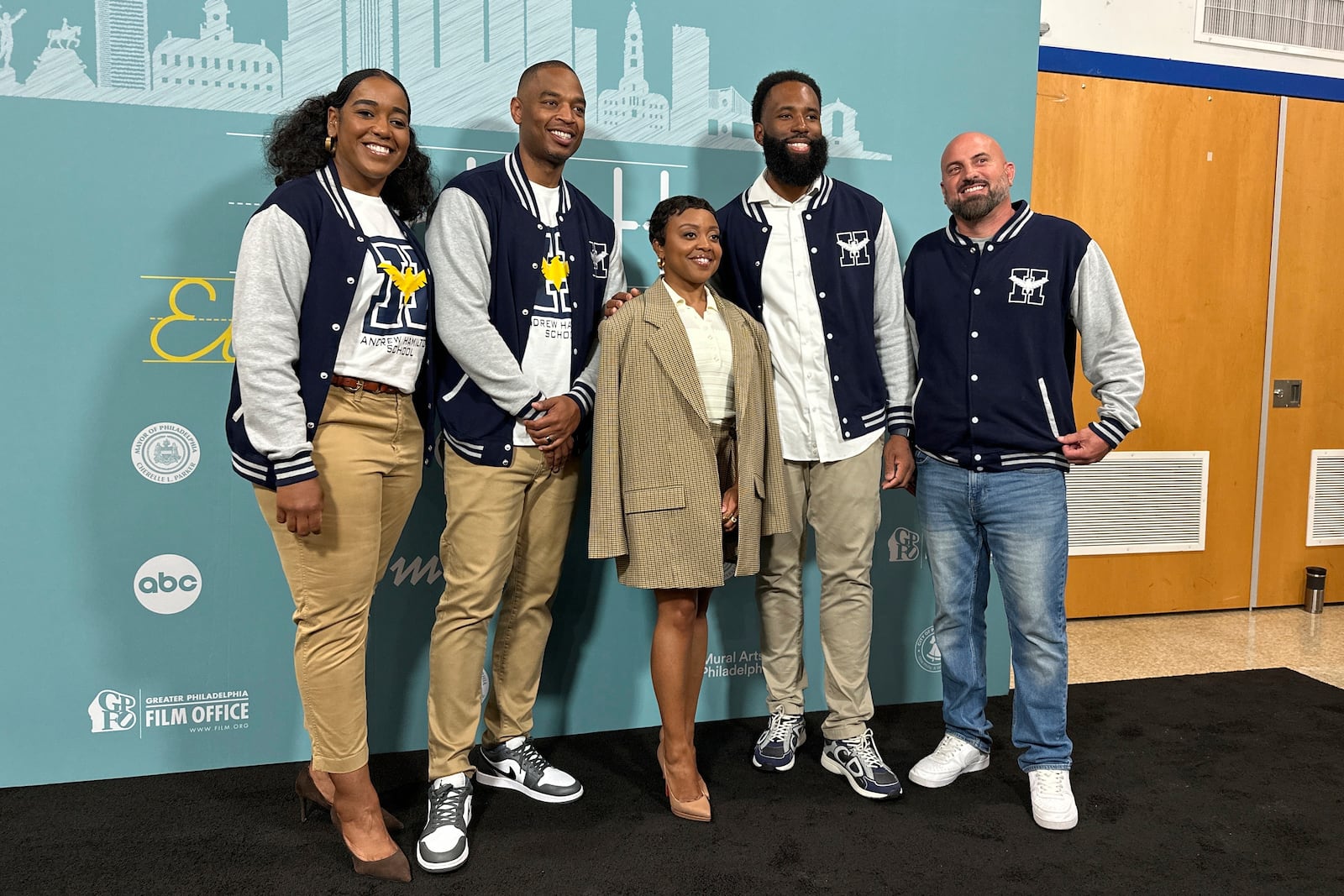 Actor Quinta Brunson, center, poses with unidentified teachers, before receiving a key to the city in a ceremony dedicating a mural at Brunson’s alma mater, Andrew Hamilton School, which was the inspiration for her award-winning show “Abbott Elementary”, Wednesday, May 28, 2025, in Philadelphia. (AP Photo/Tassanee Vejpongsa)