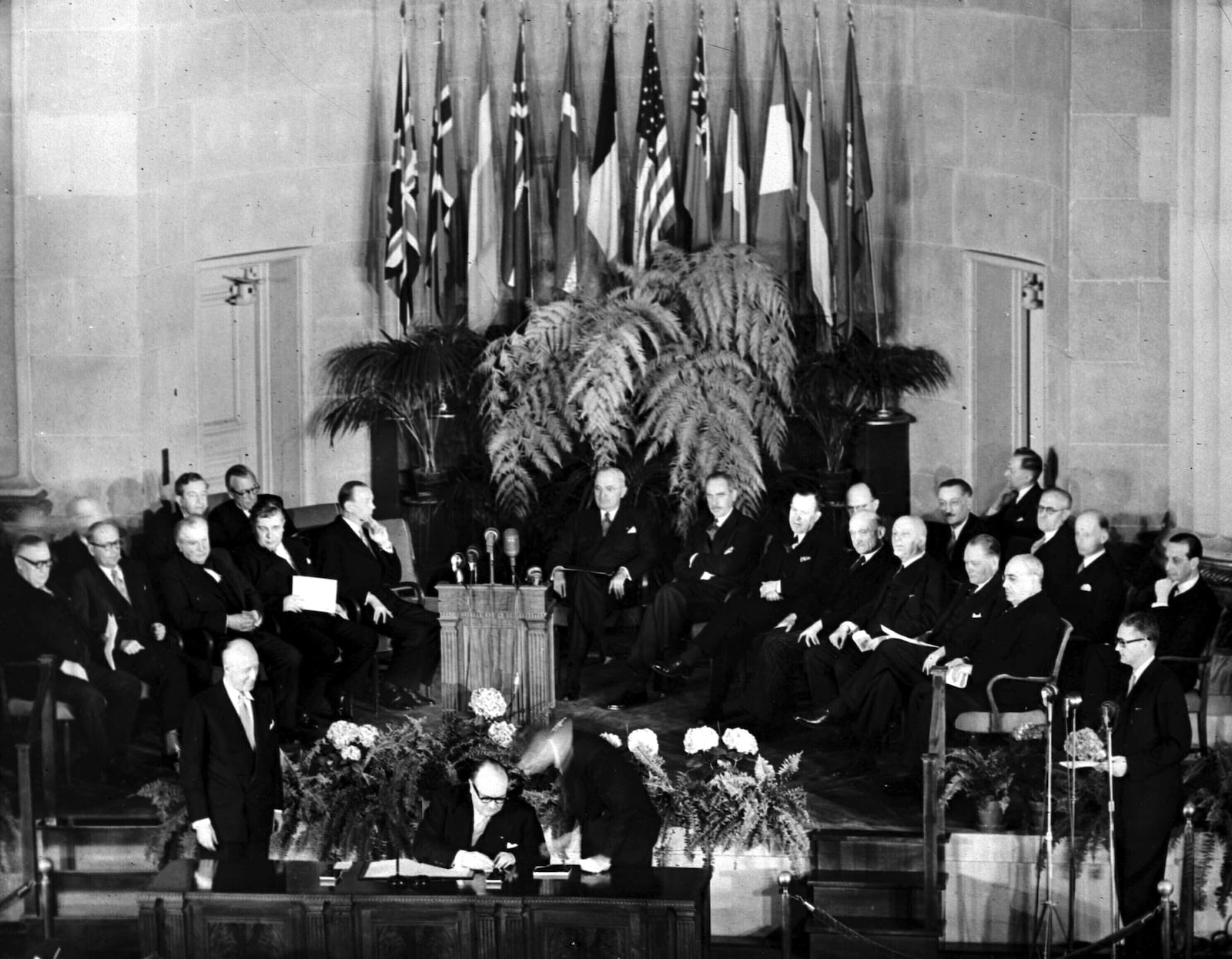 FILE - Belgium's Prime Minister Paul-Henri Spaak, seated center, signs the North Atlantic Pact in Washington, DC, April 4, 1949, flanked by Belgium's Ambassador to the U.S., Baron Silvercruys, left, and John W. Foley of the U.S. State Department. Seated behind, from left, are Britain's Ernest Bevin, Norway's Halvard Lange, Luxembourg's Joseph Bech, Iceland's Bjarni Benediktsson, Denmark's Gustav Rasmussen, U.S. President Harry S. Truman, U.S. Secretary of State Dean Acheson; Canada's Lester Pearson, France's Robert Schuman, Italy's Count Carlo Spforza, Holland's Dirk Stikker and Portugal's Jose Caeiro Da Matta. (AP Photo, File)