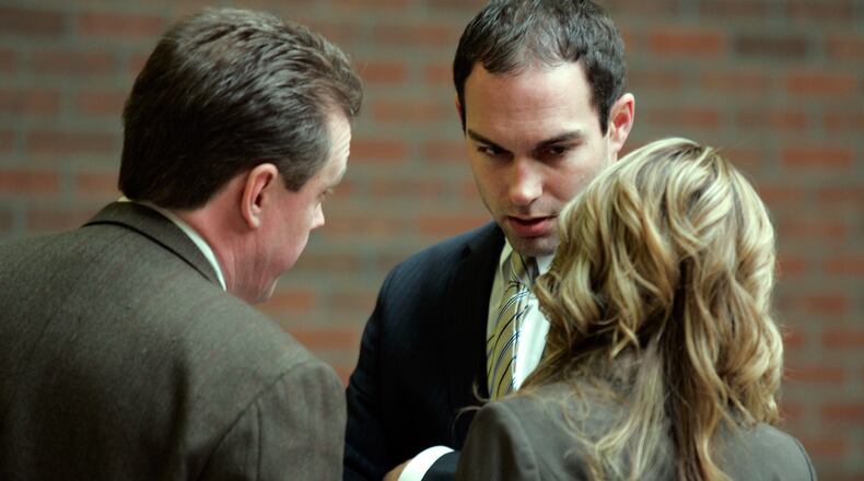 Ryan Widmer talks with attorneys Jay Clark and Lindsey Guiterrez just before entering Judge Neal Bronson's court room Tuesday, Feb. 15, 2011 in Warren County Common Pleas Court in Lebanon, Ohio. Widmer was found guilty in the drowning death of his wife Sarah Widmer.
