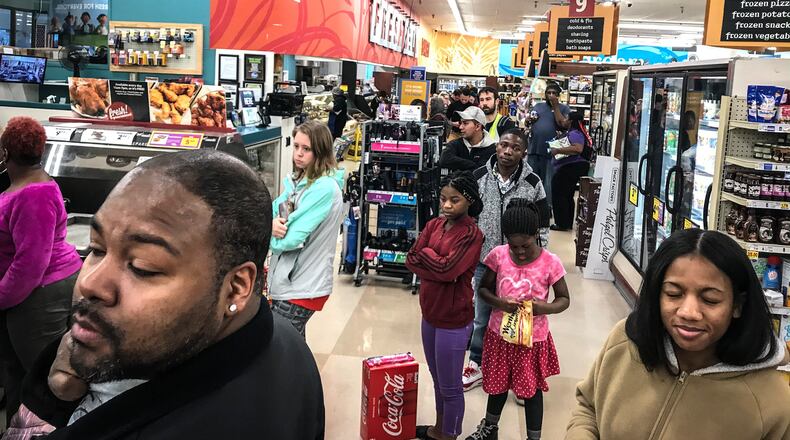 Shoppers at the Kroger’s on Wayne Ave. waited in line over a half and hour to get provisions Thursday night. Because of the coronavirus, the City of Dayton issued a state of emergency. JIM NOELKER/STAFF